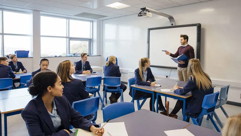 Teacher talking to students in a classroom