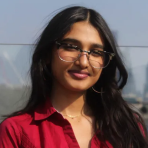 Neha in front of a cityscape