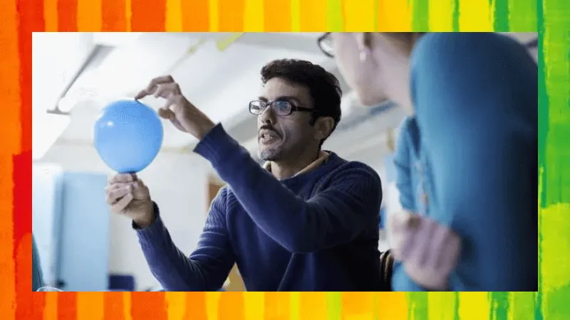 A teacher showing a student a science experiment with a balloon.