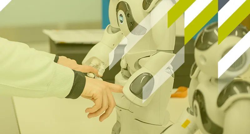 A robot gently holds hands with a human