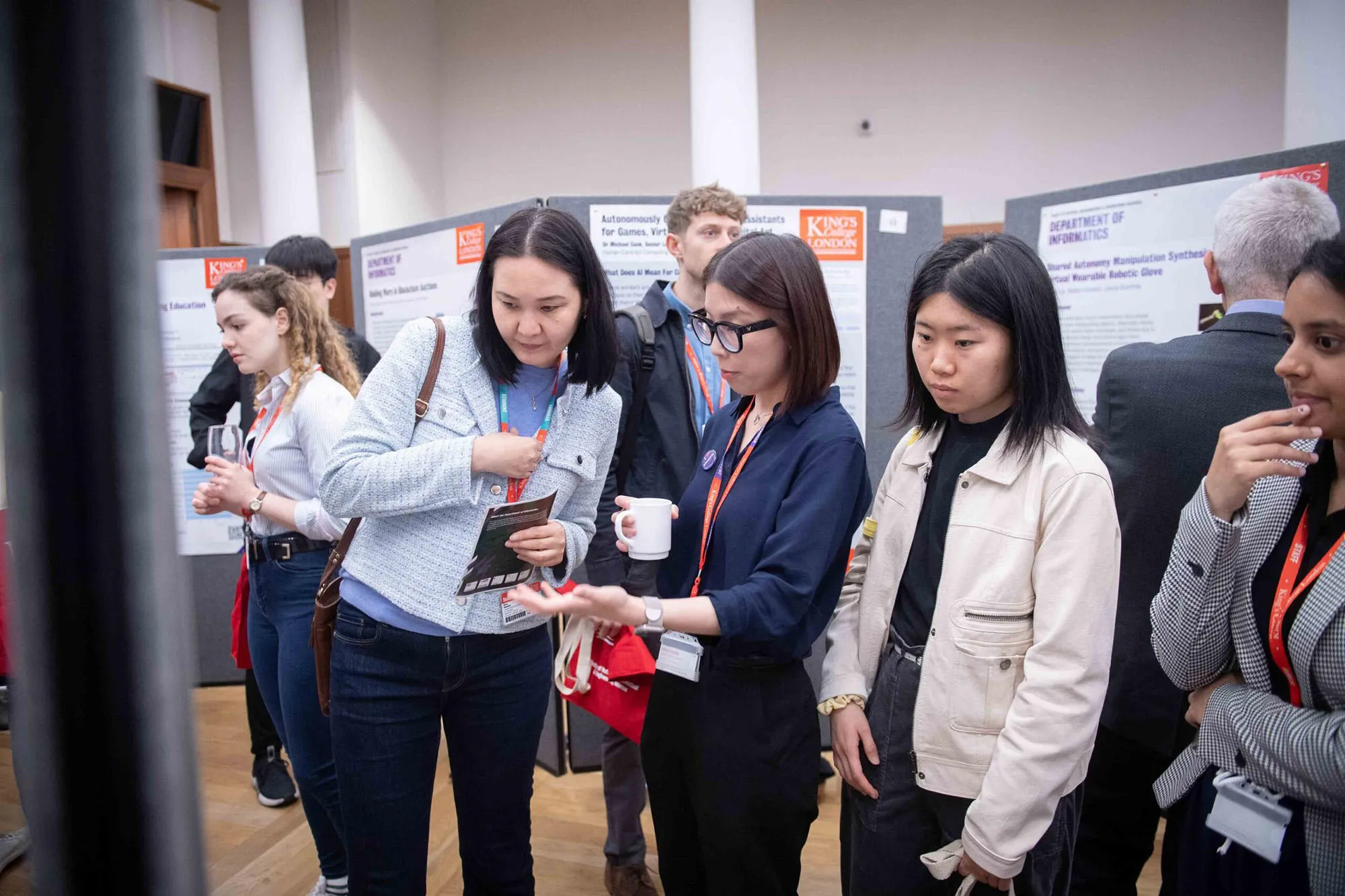 A group of people looking at a poster