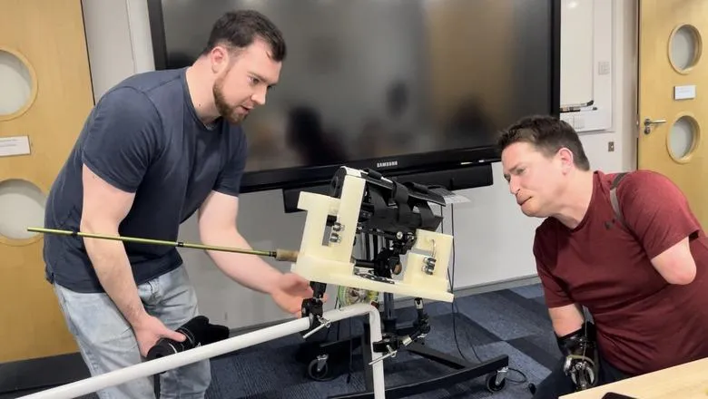 King’s Engineering student Jack Doyle with Alex Lewis, demonstrating a one-handed prosthetic for fly fishing.