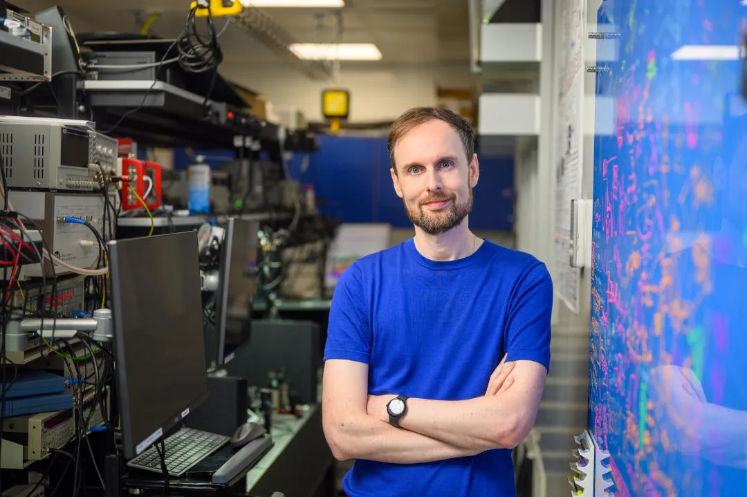 White male in blue shirt in a lab