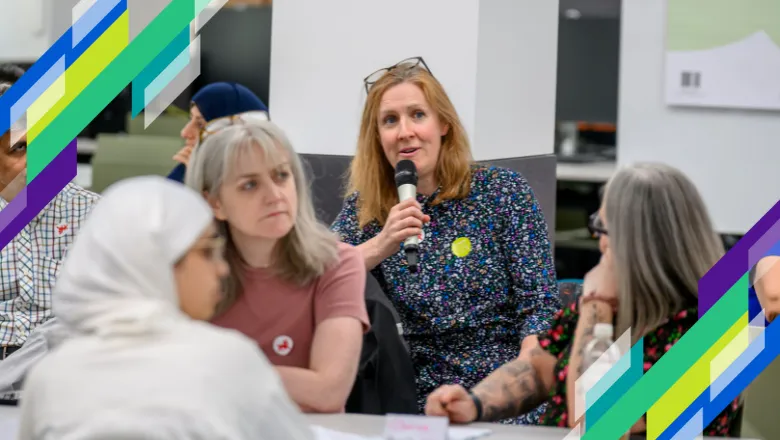 A group of teachers, one holds a microphone