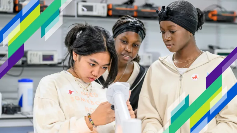 Three girls look at science experiment