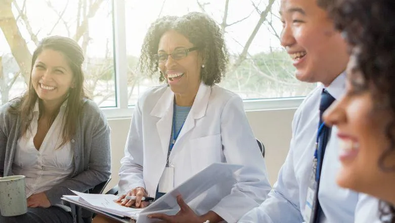 Medical staff smiling and chatting in a group