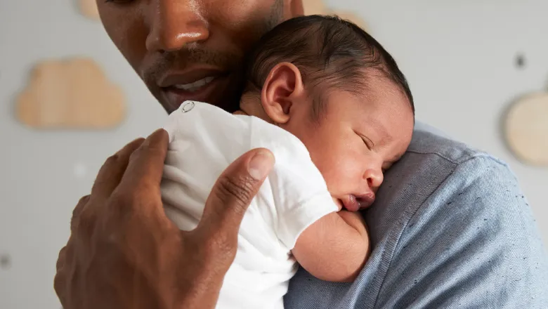 A father cradling a baby