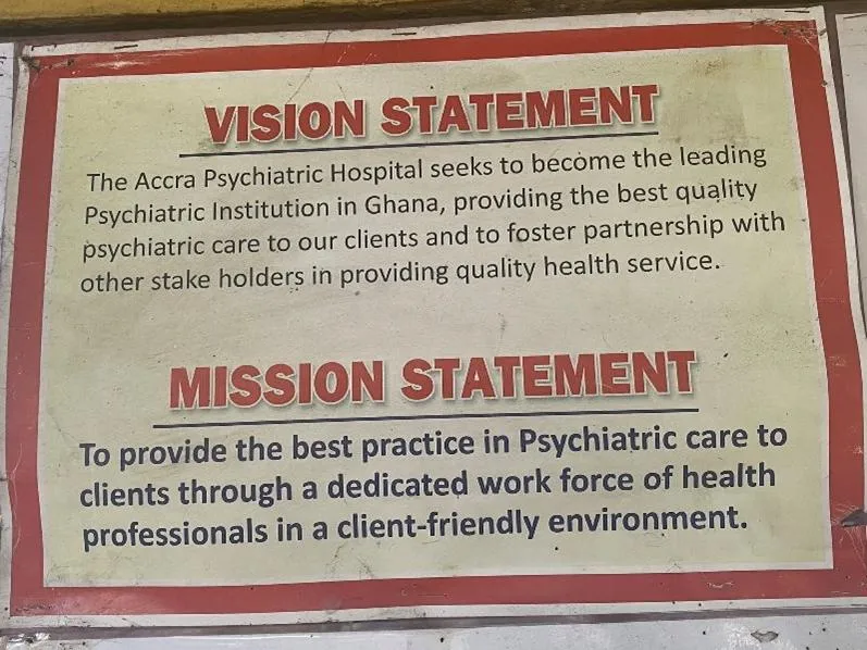 The vision statement and mission statement of a psychiatric hospital in Ghana posted on a printed out sign.