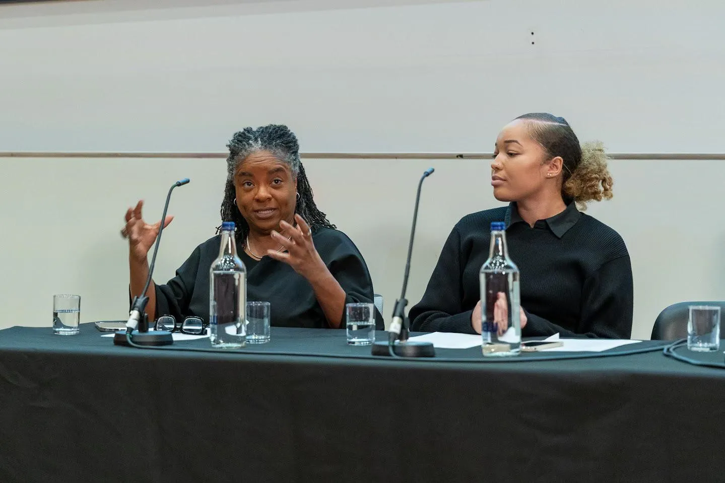 Two women speaking at event