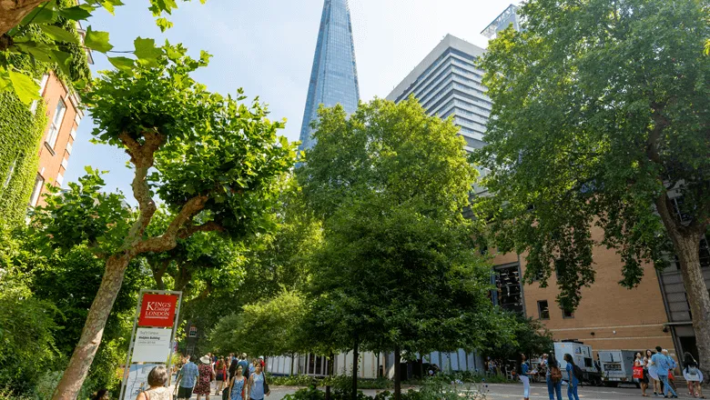 Outside Guy's Campus on a bright and sunny day, with a view of the Shard in the background.