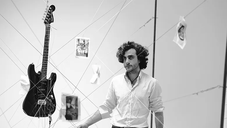 Dr Pablo de Orellana inside the installation “playing” the guitar. Worlding Art Residency and Project Space in May 2023.