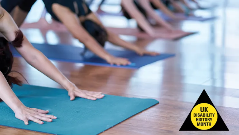 Several people engaged in a yoga session inside a gym, demonstrating various poses and maintaining a serene atmosphere.