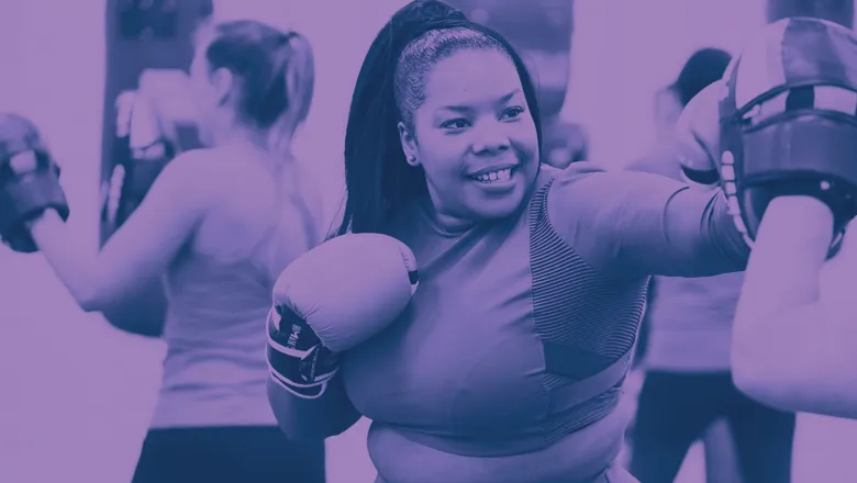 Women participating in a boxing class, showcasing their skills and determination in a supportive training atmosphere.