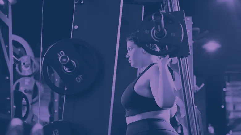  A woman holding a barbell on her shoulders.