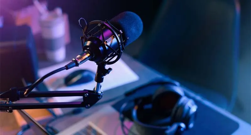 Studio microphone and headphones on a desk