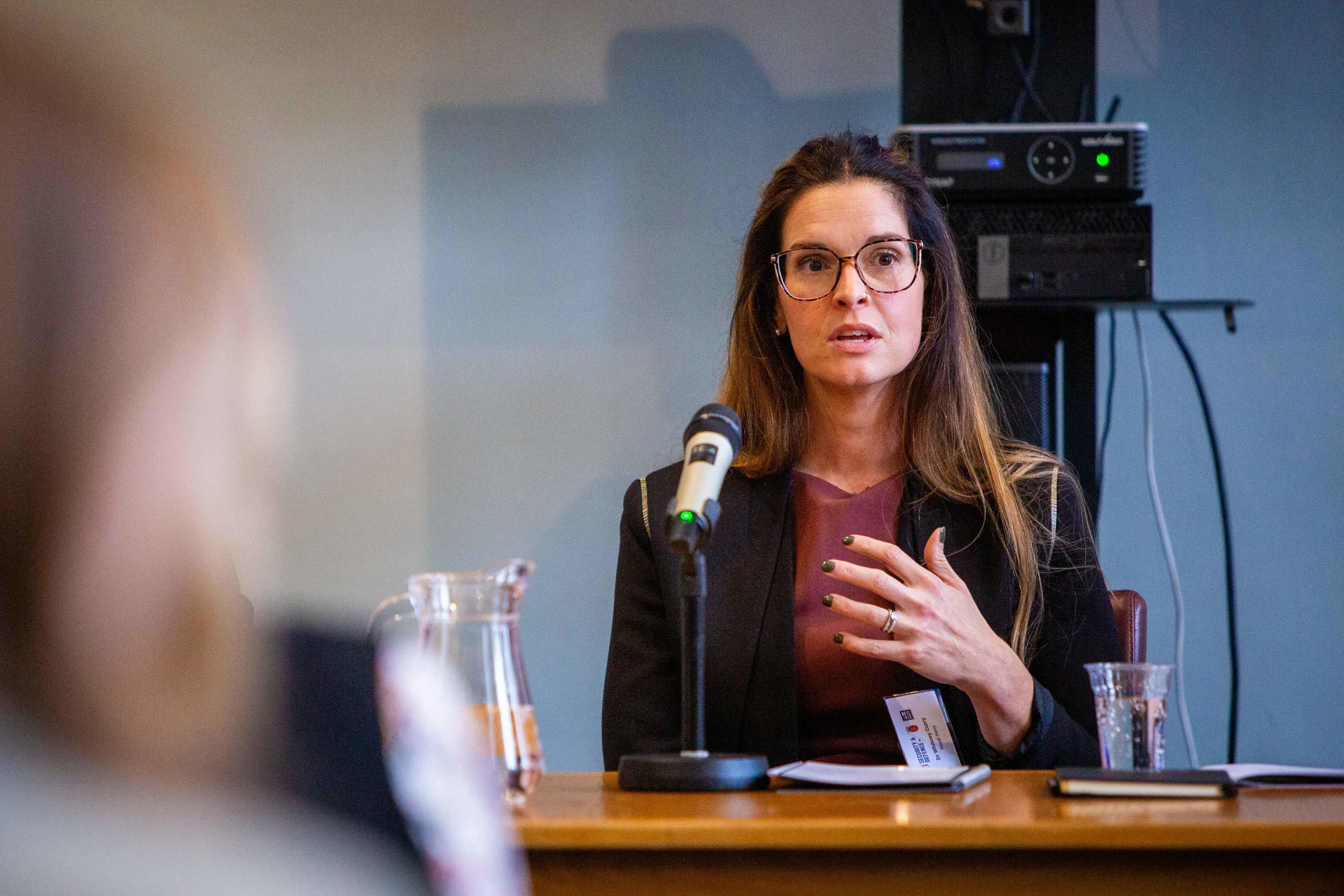 Close-up of Dr Whitney Curry, Head of Health and Wellbeing, Royal Navy as she speaks into a microphone