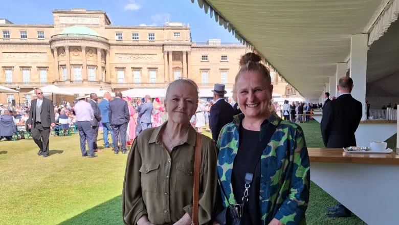Two people at a garden party at Buckingham Palace
