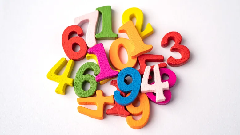 wooden numbers laid out on white background