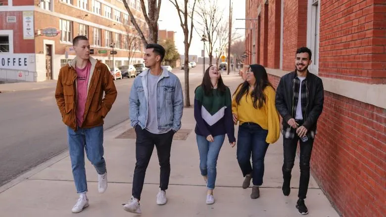 Young people walking down street - by eliott reyna - 780x440