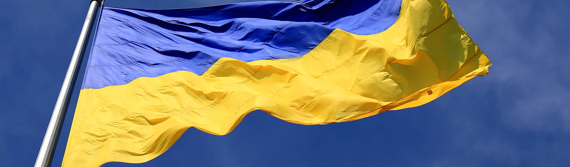 Ukraine flag fluttering against a blue sky