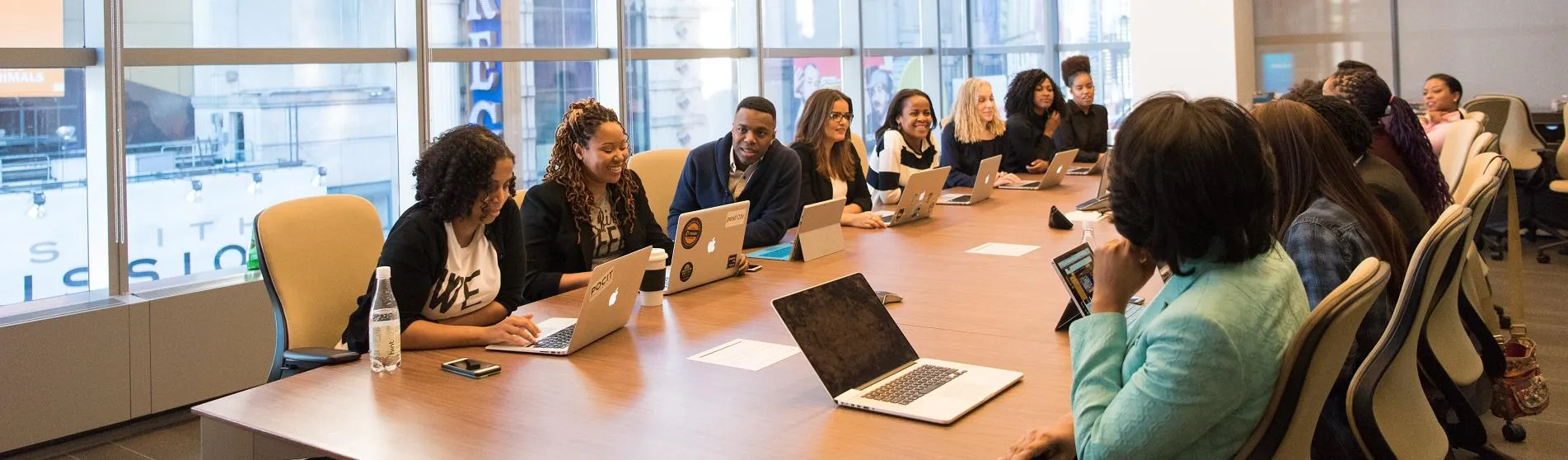 A diverse group of women and men around a boardroom table