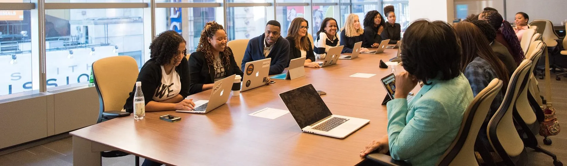 A diverse group of women and men around a boardroom table