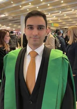 Smiling student in graduation robes