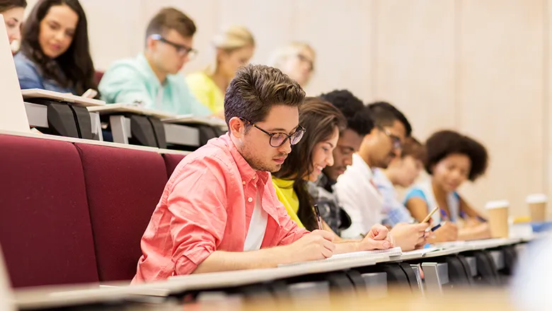 University students writing in lecture theater